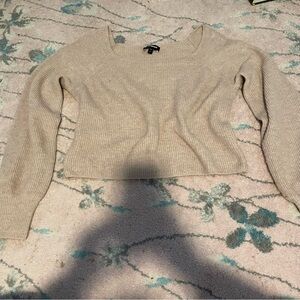 Express Cream and tan sweater with a slight flare at the bottom of sleeve